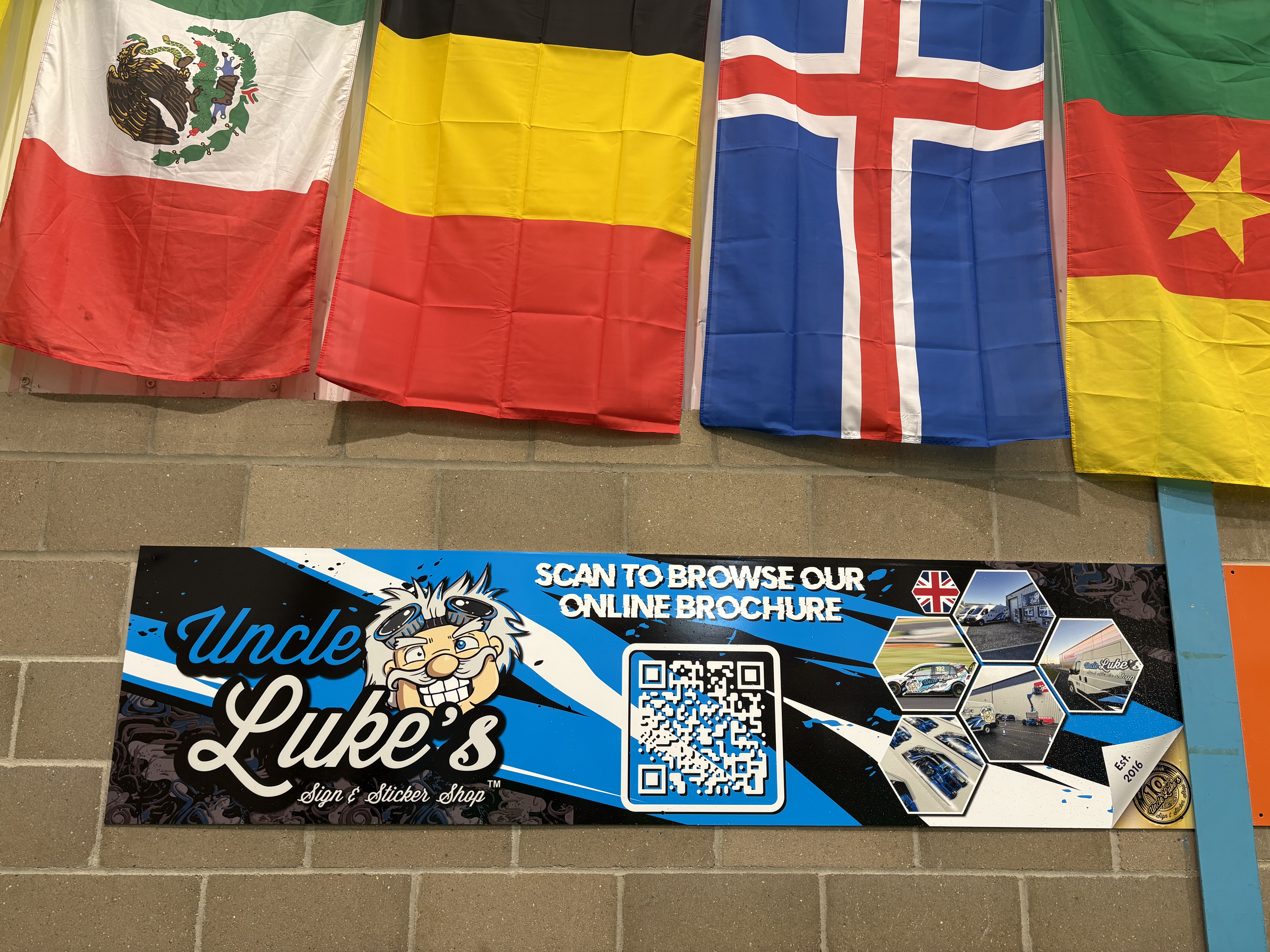 Uncle Luke's Sign & Sticker Shop sponsor board at The Inspire Arena